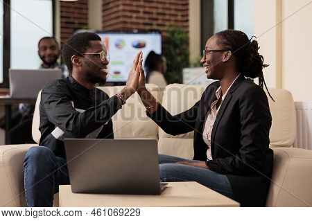 Team Of Coworkers Giving Highfive At Job, Doing Work Collaboration On Business Presentation And Data