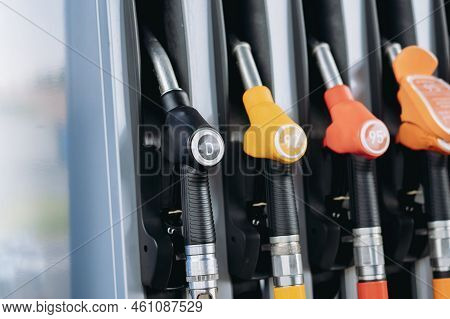 Petrol Pump Filling Fuel Nozzles At Gas Station