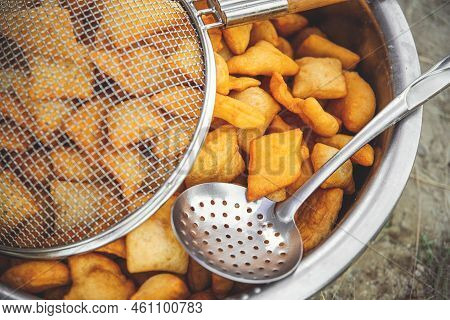 Traditional Kazakh And Central Asian Fresh Baursaks In A Large Dish With A Colander And Slotted Spoo