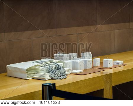 Paris, France - Nov 3, 2021: Multiple Cardboard Packages With Ear Pods, Usb-c Power Adapters, Lighte