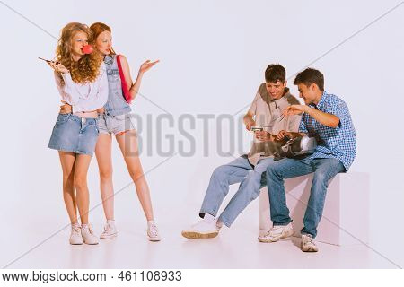 Groupf Of Young Stylish People, Students Posing Isolated Over Grey Background. Jeans Fashion.