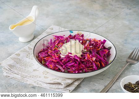 Coleslaw Salad Of Red Cabbage And Carrots With Mayonnaise Dressing In A White Bowl On A Gray Concret