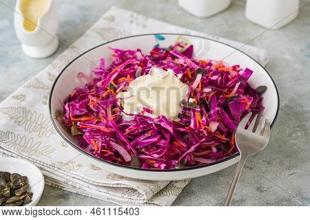 Coleslaw Salad Of Red Cabbage And Carrots With Mayonnaise Dressing In A White Bowl On A Gray Concret
