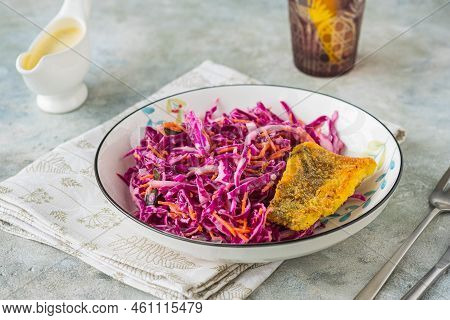 Grilled Fish With Red Cabbage And Carrot Colslow Salad With Mayonnaise Dressing In A White Bowl On A