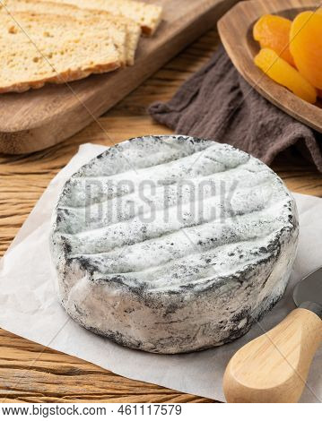 Brazilian Artisan Lua Cheia Cheese With Toasts And Fruits Over Wooden Table.