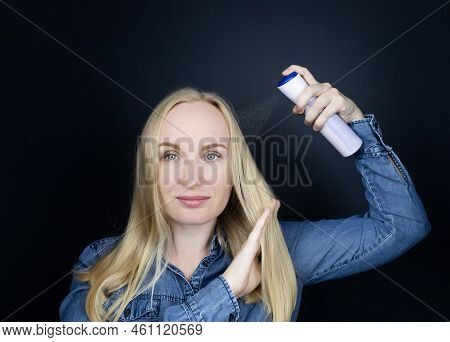 Dry Shampoo. Blonde Girl Sprays Shampoo On Her Hair. The Problem Of Oily Hair While Traveling. An Em