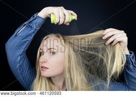 Dry Shampoo. Blonde Girl Sprays Shampoo On Her Hair. The Problem Of Oily Hair While Traveling. An Em