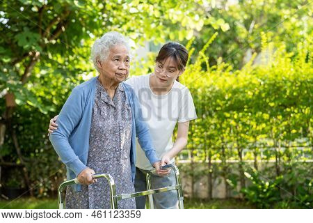 Caregiver Help And Care Asian Senior Or Elderly Old Lady Woman Use Walker With Strong Health While W