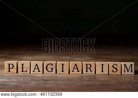 Wooden Cubes With Word Plagiarism On Table, Space For Text