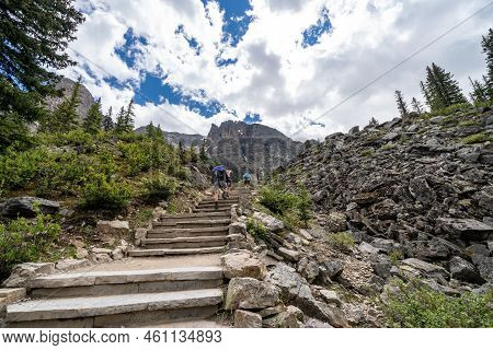 Lake Louise, Alberta, Canada - July 9, 2022: Tourists Climb Up The Stairs Along The Famous Rockpile 