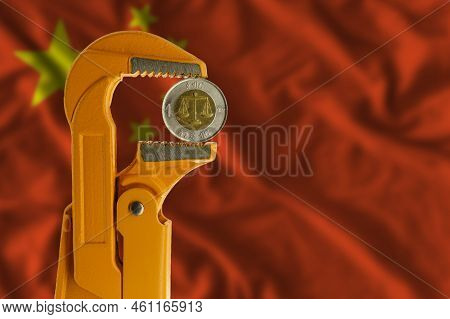 Ethiopian One Birr Coin Held In An Orange Plumber Wrench On The Background Of The Flag Of China. Rev