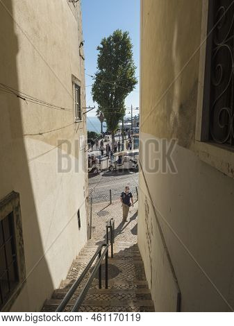 Lisbon, Portugal, October 24, 2021: View Of Narrow Street With Strairs Leading To River At Medieval 