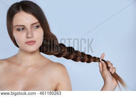 Young Woman With Strong Healthy Braided Hair On Light Blue Background, Space For Text