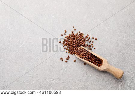 Scoop With Buckwheat Tea Granules On Light Grey Table, Top View. Space For Text