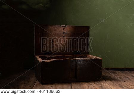Vintage Old Box In Green. Wooden Box For Things. A Box In A Dark Room. Front View.
