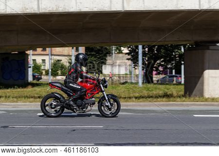 Red Motorcycle Is Driving On Street. Ducati Monster 695. Riga, Latvia - 04 Sep 2022.