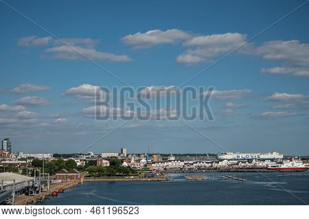 Southampton, England, Uk - July 7, 2022: Harbor Scenery. Red Funner Ferry Boat At Its Dock With Buil