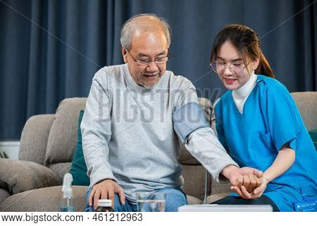 Asian Doctor Woman Examine Do Checking Old Man Client Heart Rate With Pulsimeter Monitor, Nurse Visi