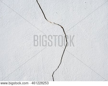 Vertical Crack Bisecting The White Painted Wall