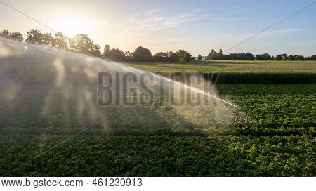Aerial View By A Drone Of An Agricultural Field Being Irrigated By A Gigantic And Powerful Irrigatio