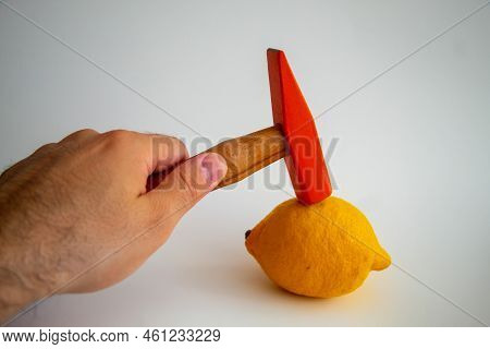 Hand Held Wooden Handle Hammer And Orange Head, On The Lemon, Isolated White Background, Straight Pe