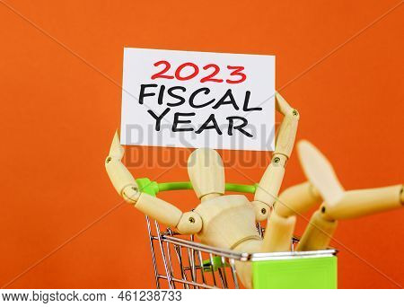 2023 Fiscal Year Symbol. White Paper With Words 2023 Fiscal Year, Clip On Wooden Clothespin. Human M