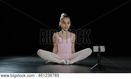 Teen Girl Dancer Gymnast Acrobat Ballerina Child Making Butterfly Stretch Exercise Sitting On Floor 