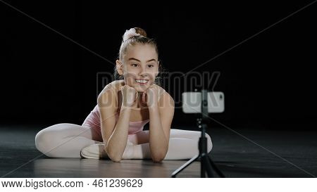 Young Teen Girl Child Teenager Ballerina Gymnast Dancer Sitting On Floor Recording Vlog Waving Hello