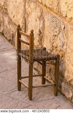 A Chair Without View On A Street In Montepulciano