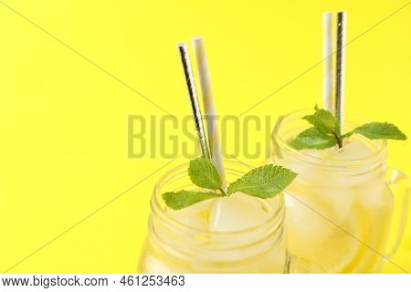 Natural Freshly Made Lemonade With Mint On Yellow Background, Closeup. Summer Refreshing Drink