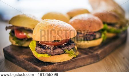 Six Burger On Wooden Plates But One Close Up Shot Picture Of Burger With Full Of Delicious Ingredien