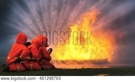 Firefighter Rescue Team Training In Fire Fighting Extinguisher. Firefighter Teamwork Fighting With F