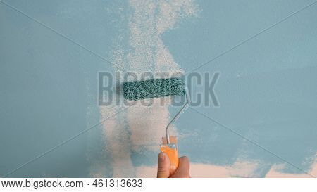 Hand Painting The Wall With Decorator Roller And Painting Walls. Master Painter Services