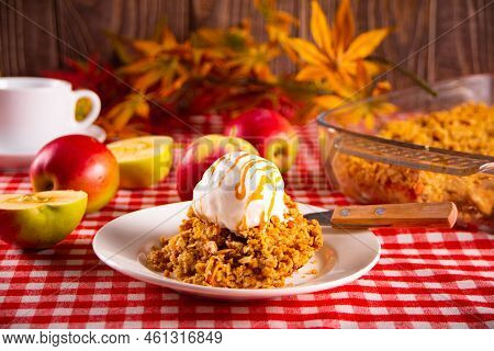 Homemade Apple Cramble Crisp Cake On White Plate With Autumn Leaves On The Background