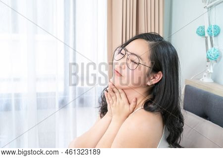 Asian Glasses Woman Relax On Her Bed In The Morning At Her Bedroom.