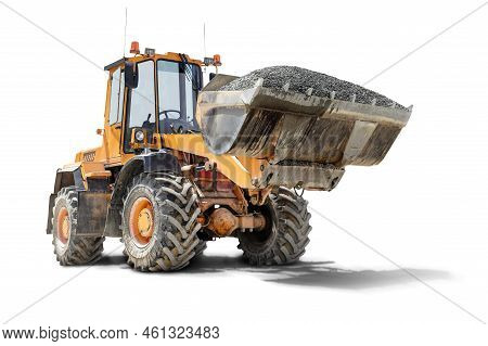 A Large Front Loader Transports Crushed Stone Or Gravel In A Bucket At A Construction Site. Transpor