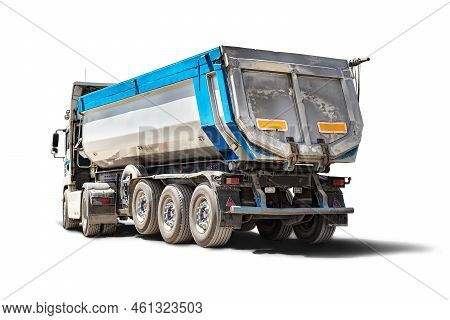 A Large Dump Truck Unloads Rubble Or Gravel At A Construction Site. Car Tonar For Transportation Of 