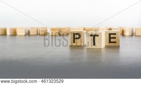 Three Wooden Blocks With Letters Pte, Grey Background, Pearson Tests Of English Concept