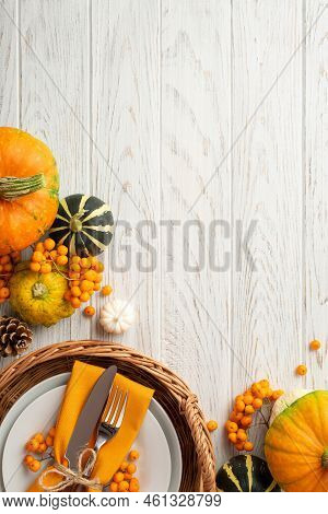Thanksgiving Day Concept. Top View Vertical Photo Of Rattan Tray With Plate Knife Fork Napkin Pumpki