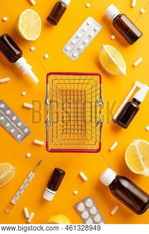 Healthcare Concept. Top View Vertical Photo Of Empty Shopping Cart Medicines Spray And Syrup Transpa