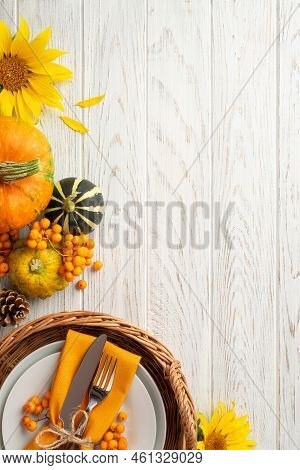 Autumn Harvest Concept. Top View Vertical Photo Of Rattan Tray With Plate Knife Fork Napkin Sunflowe