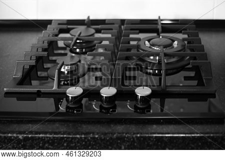 Black Built-in Gas Stove On A Black Countertop. Kitchen Interier.