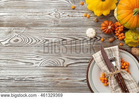 Autumn Harvest Concept. Top View Photo Of Plate Knife Fork Napkin Raw Vegetables Pumpkins Pattypans 