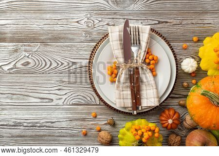 Thanksgiving Day Concept. Top View Photo Of Table Setting Plate Napkin Knife Fork Raw Vegetables Pum