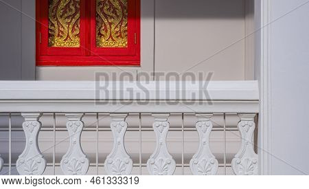 Sunlight On Traditional Pattern Surface Of White Fence With Red And Golden Wooden Window On White Co