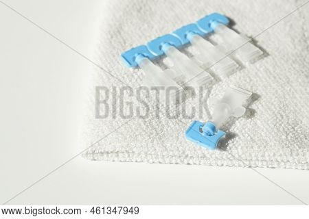Single Dose Eye Drops And Towel On White Table, Closeup