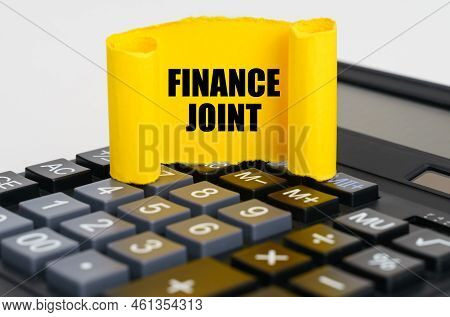 Business Concept. On The Calculator Is A Yellow, Twisted Paper Plate With The Inscription - Finance 