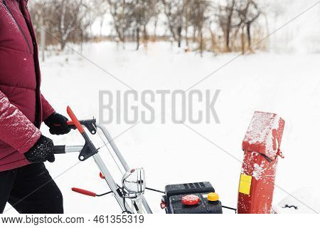 Detail Of Portable Red Snow Blower Powered By Gasoline In Action. Man Outdoor Using Snowblower Machi