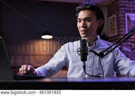Asian Man Broadcasting Online Podcast Show On Vlogging Channel, Recording Video At Radio Sound Stati