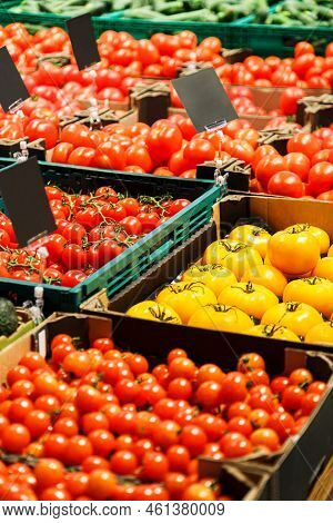 Fresh Colourful Tomatoes In Boxes At Market.
